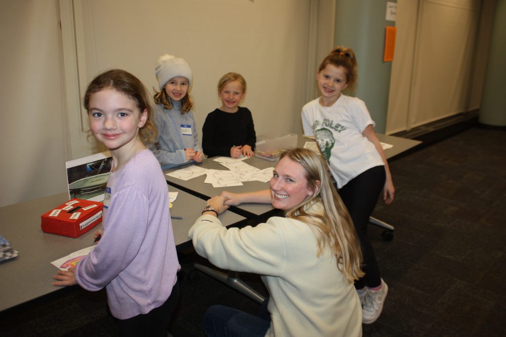 Campers showcasing their handmade arts and crafts at the camp