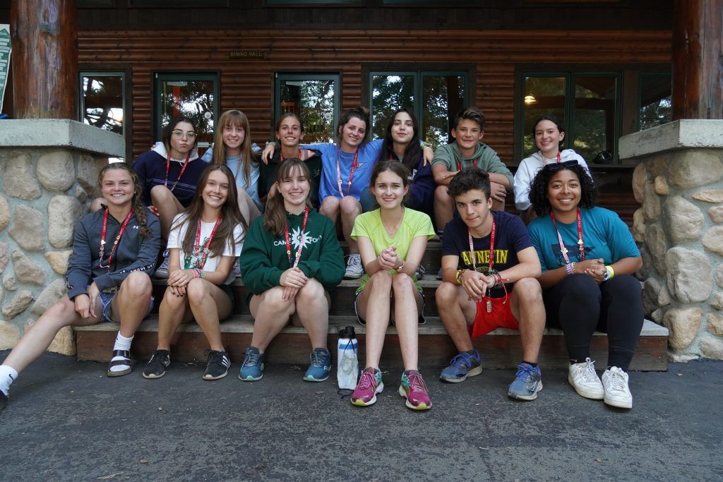 Camp counselors facilitating a group activity at a coed summer camp