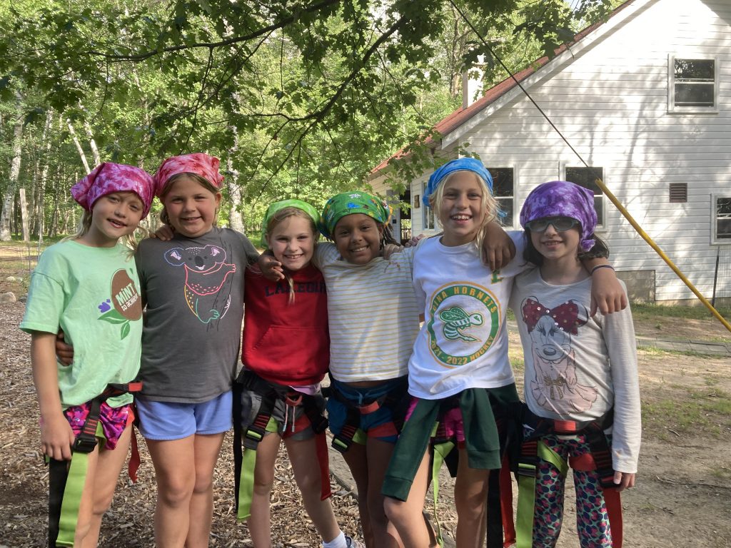 Diverse group of children participating in different activities at a co-ed summer camp in Duluth, MN