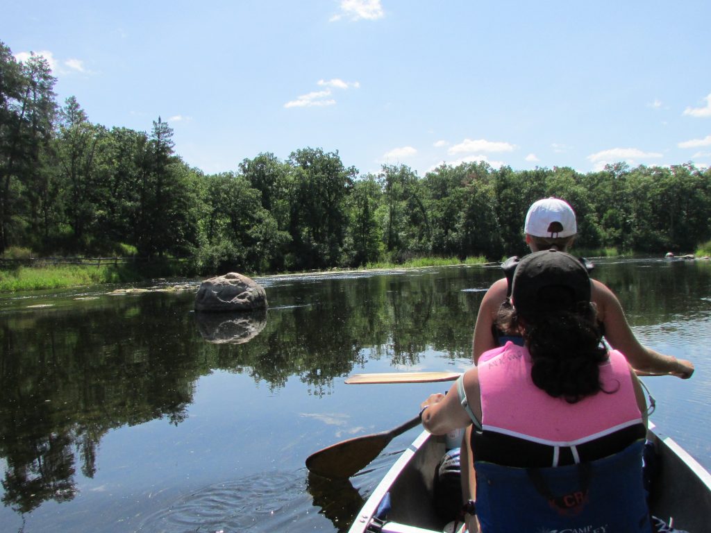 Children participating in wilderness exploration and survival skills activity at a Minnesota co-ed summer camp