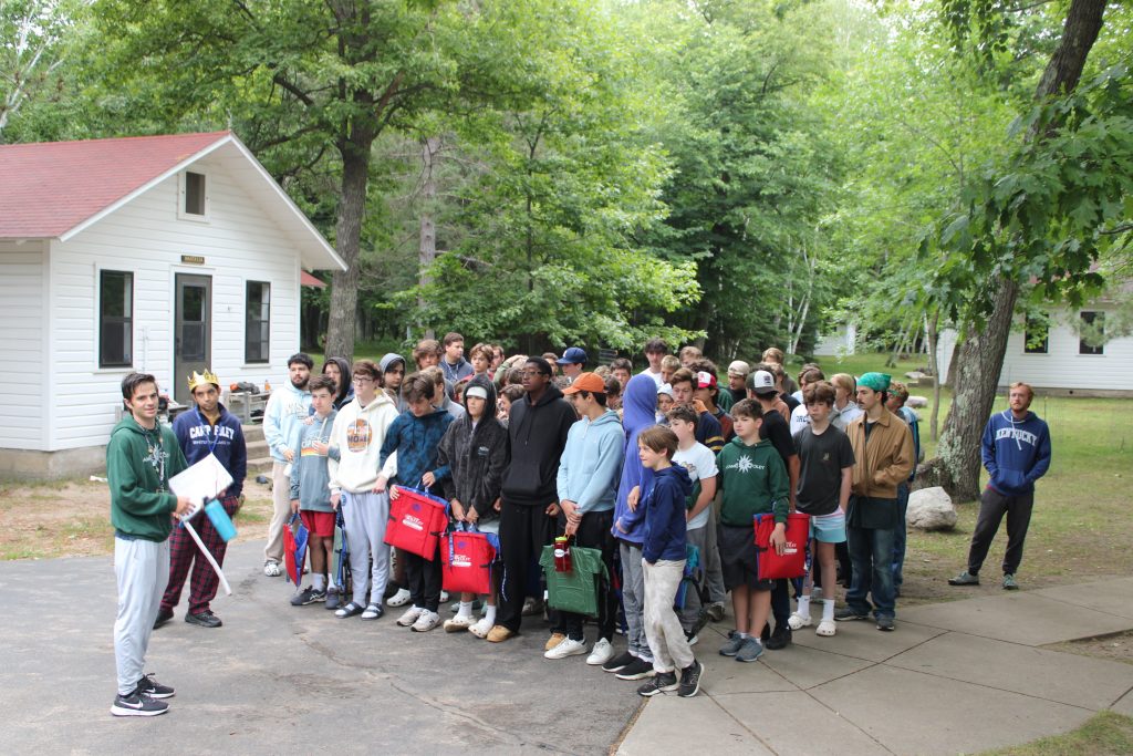 Boy campers grouped together on the boys end waiting to march 