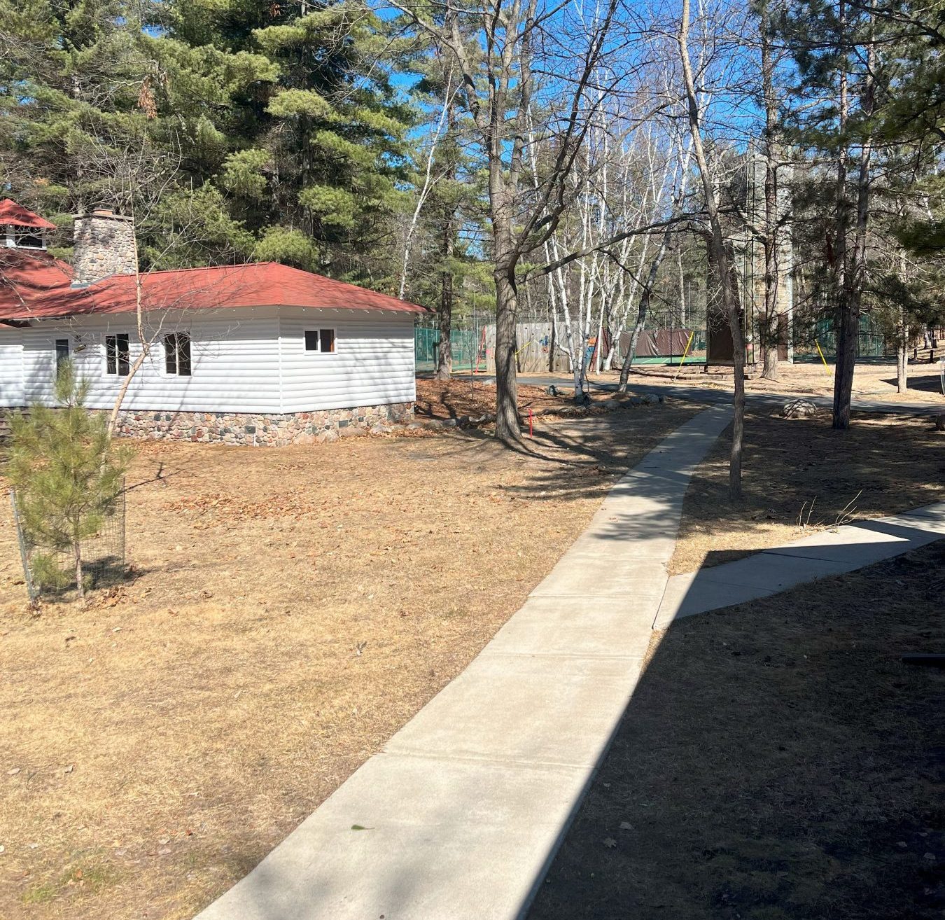 Landscape look at Camp Foley with 1 white building in the background 